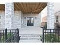 Inviting covered front porch features stone columns and double doors for stylish curb appeal at 1432 Fairmont Ave, Atlanta, GA 30318