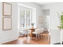 Charming dining area with a round table, modern chairs, and bench seating, bathed in natural light from large windows at 1585 S Ponce De Leon Ne Ave # 19, Atlanta, GA 30307