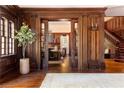 Grand entryway features dark wood paneling, staircase, and view to living room at 1585 S Ponce De Leon Ne Ave # 19, Atlanta, GA 30307