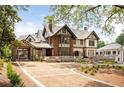 Elegant home featuring beautiful brick and stucco architecture and a gravel driveway with manicured landscaping at 1585 S Ponce De Leon Ne Ave # 19, Atlanta, GA 30307