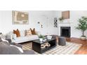 Well-lit living room featuring a decorative fireplace, hardwood floors, and comfortable seating arrangement perfect for relaxation at 1585 S Ponce De Leon Ne Ave # 19, Atlanta, GA 30307