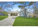 Attractive single-Gathering house showcasing a carport, neat landscaping, and a welcoming facade at 200 Harvell Dr, Bowdon, GA 30108