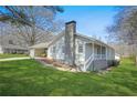 Inviting home exterior boasting a quaint front porch, brick accents, and mature trees at 200 Harvell Dr, Bowdon, GA 30108