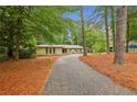Attractive front exterior of home with long driveway and lots of trees at 11540 Northgate Way, Roswell, GA 30075