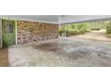 View of attached carport showing brick construction, direct access to the house, and view to front yard at 1725 Timberland Ne Rd, Atlanta, GA 30345