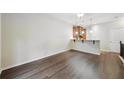 Open-concept living space featuring hardwood floors, with a bar-top dining area creating an inviting atmosphere at 215 Semel Nw Dr # 455, Atlanta, GA 30309
