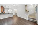 Open-concept living area featuring hardwood floors and staircase access, perfect for modern living at 215 Semel Nw Dr # 455, Atlanta, GA 30309
