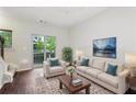 Bright living room with hardwood floors, neutral decor, and a balcony offering relaxing views and fresh air at 215 Semel Nw Dr # 455, Atlanta, GA 30309