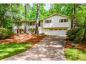 Inviting home with a well-maintained lawn, attached garage, and mature trees, offering a blend of comfort and charm at 2840 Wendy Ln, Marietta, GA 30062