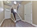 Inviting entryway with elegant staircase and hardwood floors, creating a welcoming first impression for guests at 319 Franklin Ln, Acworth, GA 30102