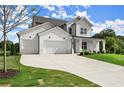 Elegant home with a pristine lawn, featuring a 3 car garage and a cozy covered front porch at 3552 Cedarvale Ct, Powder Springs, GA 30127