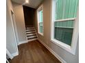 Bright hallway featuring hardwood floors, large windows, and a staircase leading to upper levels at 968 Bibbs Circle Nw, Atlanta, GA 30318