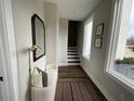 Inviting hallway with hardwood floors, a stylish mirror, bench, and ample natural light at 968 Bibbs Circle Nw, Atlanta, GA 30318