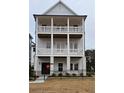 Three-story home with double balconies and a black metal fence at 1417 Coretta Scott Bnd, Atlanta, GA 30318