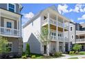 Side view of a three-story house with double porches showcasing its architectural design and neat landscaping at 1417 Coretta Scott Bnd, Atlanta, GA 30318