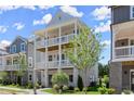 Elegant three-story house with double porches and a well-maintained lawn, ideal for enjoying the outdoors at 1417 Coretta Scott Bnd, Atlanta, GA 30318