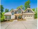 Charming two-story home features an attached two-car garage, and inviting covered entryway at 2025 Goldmine Dr, Cumming, GA 30040