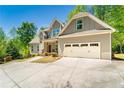 Charming two-story home features an attached two-car garage, and inviting covered entryway at 2025 Goldmine Dr, Cumming, GA 30040