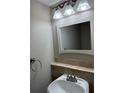 Bathroom with updated sink, stylish vanity lighting, and tile accents at 3 Fairway Nw Dr, Kennesaw, GA 30144