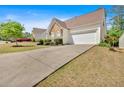 Wide driveway leading up to a charming home featuring stone accents and a two-car garage at 3321 Hampreston Nw Way, Kennesaw, GA 30144