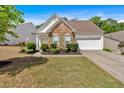 Charming home featuring stone accents, manicured landscaping, and a two-car garage at 3321 Hampreston Nw Way, Kennesaw, GA 30144