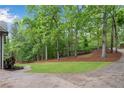 Scenic view of the home's vast yard with mature trees and a winding driveway at 1400 Squire Ln, Cumming, GA 30041