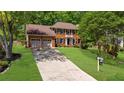 Two story brick home with an American flag, two-car garage and a sprawling front lawn at 2700 Sandstone Dr, Lawrenceville, GA 30043