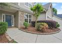 Charming home featuring a stone accent wall and a welcoming blue front door surrounded by lush landscaping at 2995 Boulder Walk Se Ct, Atlanta, GA 30316