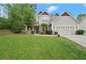 Attractive two-story home with a well-maintained lawn, mature trees, and a two-car garage at 2995 Boulder Walk Se Ct, Atlanta, GA 30316