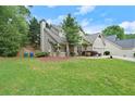 Charming home featuring a well-manicured lawn, lush trees and an inviting front porch at 2995 Boulder Walk Se Ct, Atlanta, GA 30316
