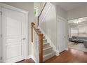 A staircase with wood handrail, hardwood floors and natural light at 2995 Boulder Walk Se Ct, Atlanta, GA 30316