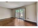 Spacious living room featuring hardwood floors and sliding glass doors to the backyard at 6593 Sleepy Hollow Ln, Morrow, GA 30260