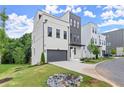 Modern two-story home with painted brick, gray accents, landscaping, driveway, and a well-manicured front lawn at 1420 Coretta Bend, Atlanta, GA 30318