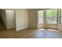 Bright living room with hardwood floors, large windows and staircase at 3432 Sumter Pl, Decatur, GA 30034