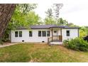 Well-maintained home with a white exterior, complemented by a neat lawn at 4215 Sherwood Ave, Decatur, GA 30035