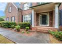 Inviting front entrance with brick walkway and meticulously landscaped shrubbery at 732 Sweet Gum Way, Canton, GA 30115