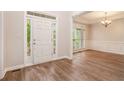 Bright entryway with wood flooring, a tray ceiling, and a view into the adjacent dining room at 732 Sweet Gum Way, Canton, GA 30115