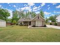 Inviting single-story home with a green lawn, showcasing a well-maintained exterior and cozy curb appeal at 74 Stonegate Ct, Dallas, GA 30157