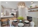 Bright dining area featuring stylish light fixture and open to updated kitchen at 1725 Redbud Way, Cumming, GA 30041