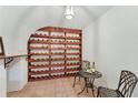 Unique wine cellar design with custom shelving and space for a tasting area at 1725 Redbud Way, Cumming, GA 30041