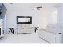 Bright living room with vaulted ceiling, modern furniture, and tile floors at 2568 Morning Glory Pl, Lawrenceville, GA 30044