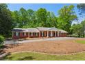 Lovely brick home with manicured lawn and a covered front entrance with white pillars at 3672 Haddon Hall Rd, Atlanta, GA 30327