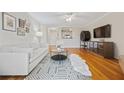 Cozy living room featuring hardwood floors, modern furniture, and a view into the kitchen at 970 Sidney Marcus Ne Blvd # 2403, Atlanta, GA 30324