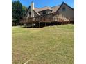Expansive backyard featuring a large wooden deck perfect for outdoor gatherings and entertaining at 1173 Jimson Se Cir, Conyers, GA 30013