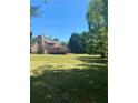 A spacious, green backyard showcasing the home's deck and outdoor potential at 1173 Jimson Se Cir, Conyers, GA 30013