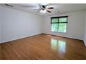 Spacious bedroom with hardwood floors, a ceiling fan, and large window at 1409 Oakridge Cir, Decatur, GA 30033
