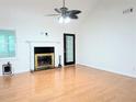 Bright living room with fireplace, ceiling fan, and gleaming hardwood floors at 1409 Oakridge Cir, Decatur, GA 30033