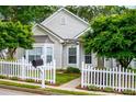 Inviting home featuring a neatly maintained lawn, a classic white picket fence, and lush surrounding greenery at 2752 Nautical Way, Villa Rica, GA 30180