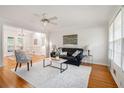 Inviting living room with hardwood floors, a ceiling fan, and a view into the dining area at 2882 Concord Dr, Decatur, GA 30033