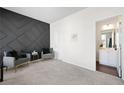 Inviting bedroom with a stylish accent wall and easy access to a well-lit ensuite bathroom at 7161 Gladstone Cir, Lithonia, GA 30038